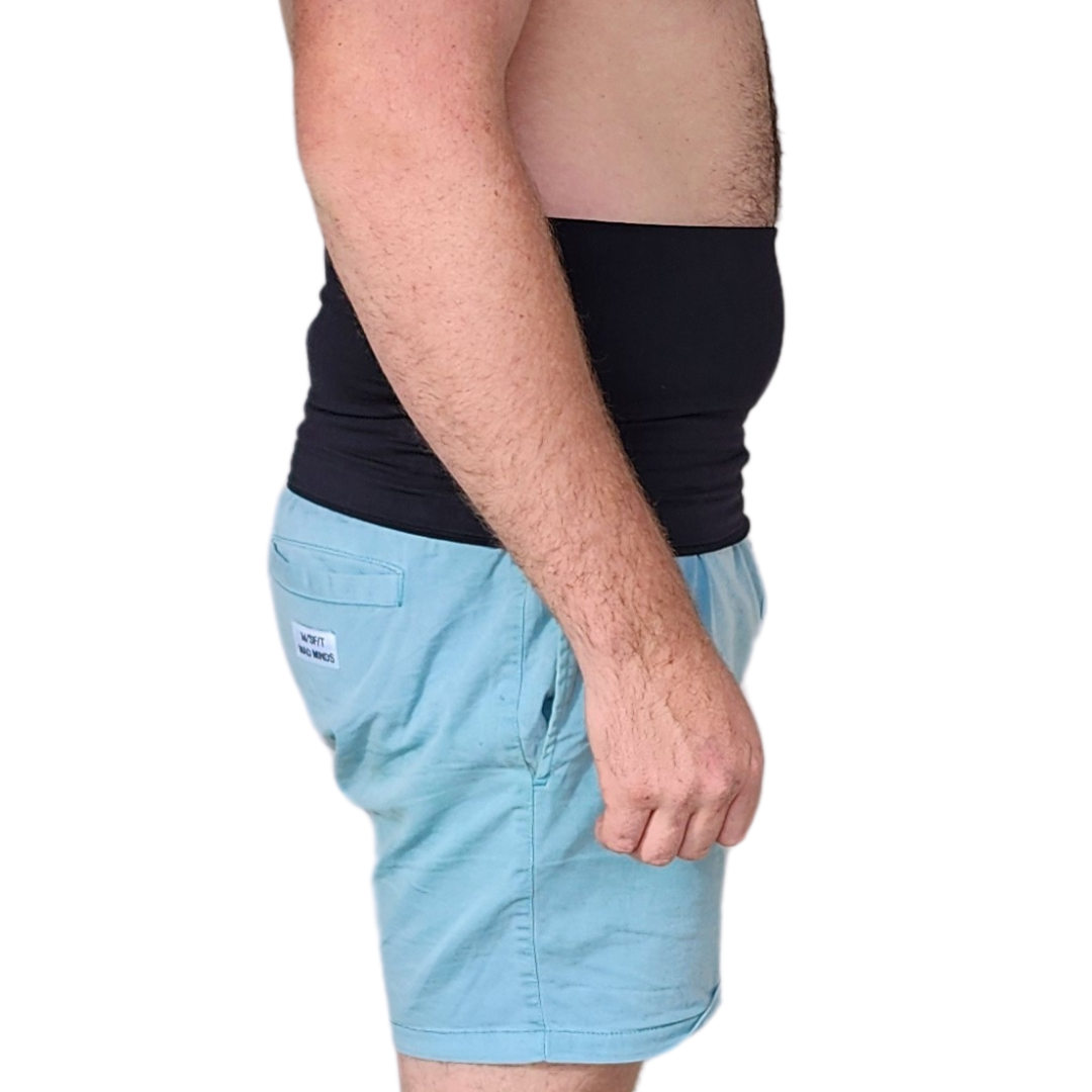 Young male wearing shorts and a black stealth belt type ostomy belt