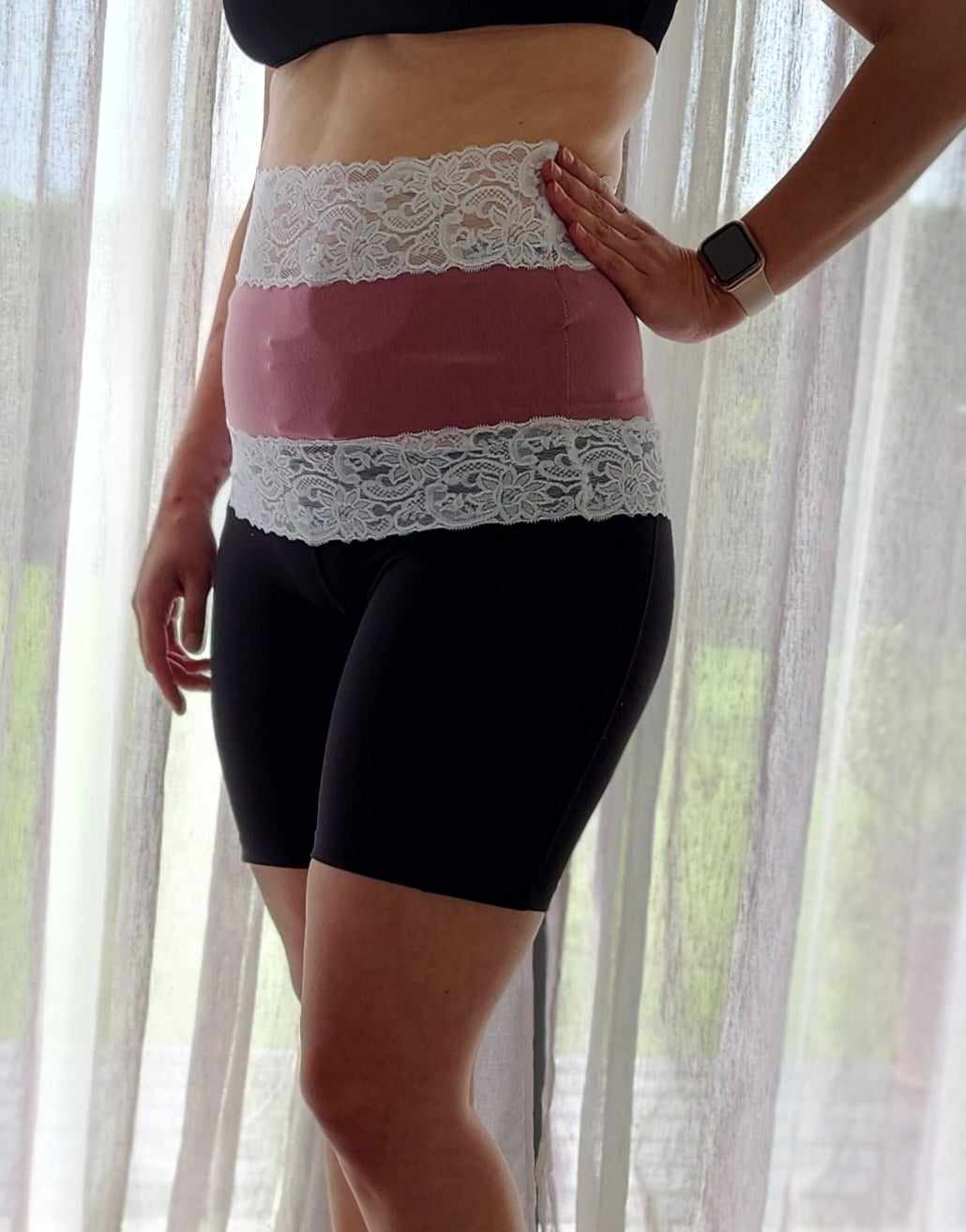 woman wearing a pink and white belly band