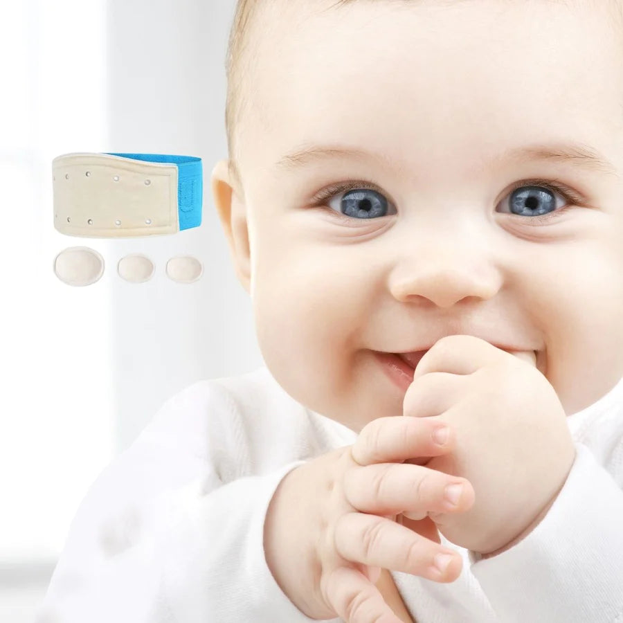 Baby smiling with fist in mouth. Baby Hernia belt photoshopped onto image, in the blue colour option.