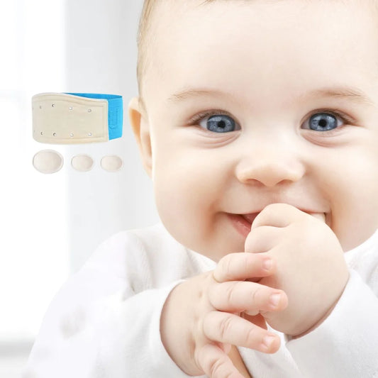 Baby smiling with fist in mouth. Baby Hernia belt photoshopped onto image, in the blue colour option.